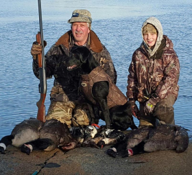 Father and son hunters and their beautiful dog