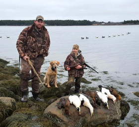 Father & son after a successful day of hunting with their dog