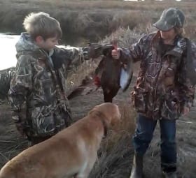 Two young boys and their trusted hunting dog